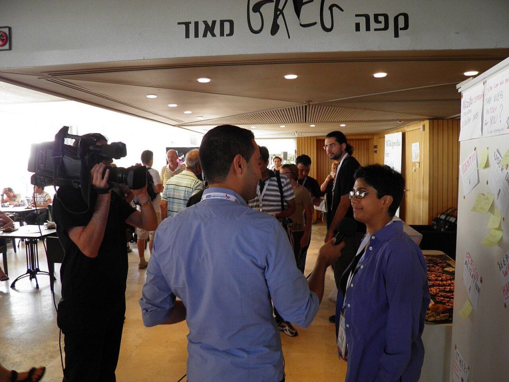 Television crew recording an interview