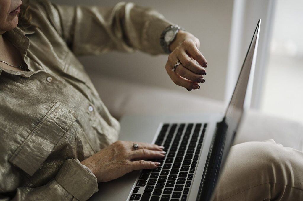 Person typing a proposal on a laptop