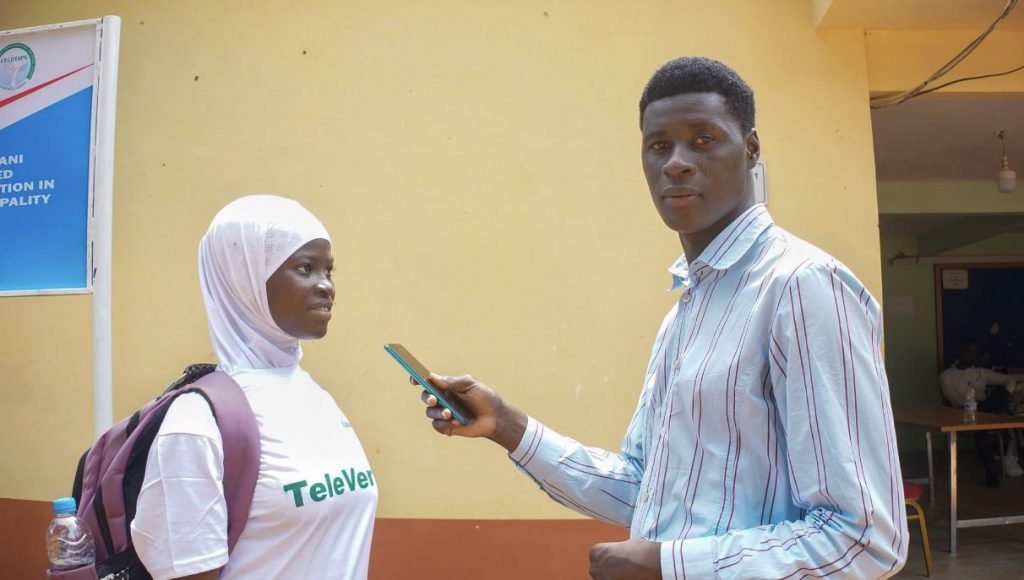 Journalist interviewing a young woman