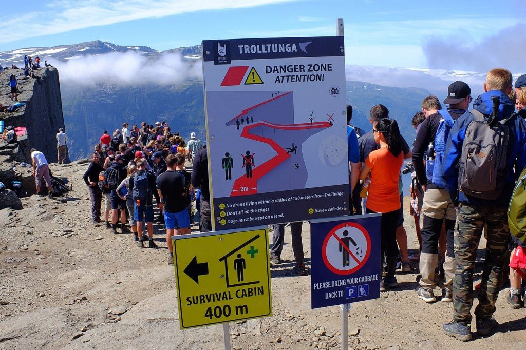 Warning signs about risks on a mountain trail