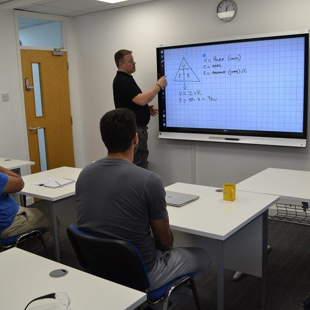 Tutor answering a question during an adult-learning classroom session