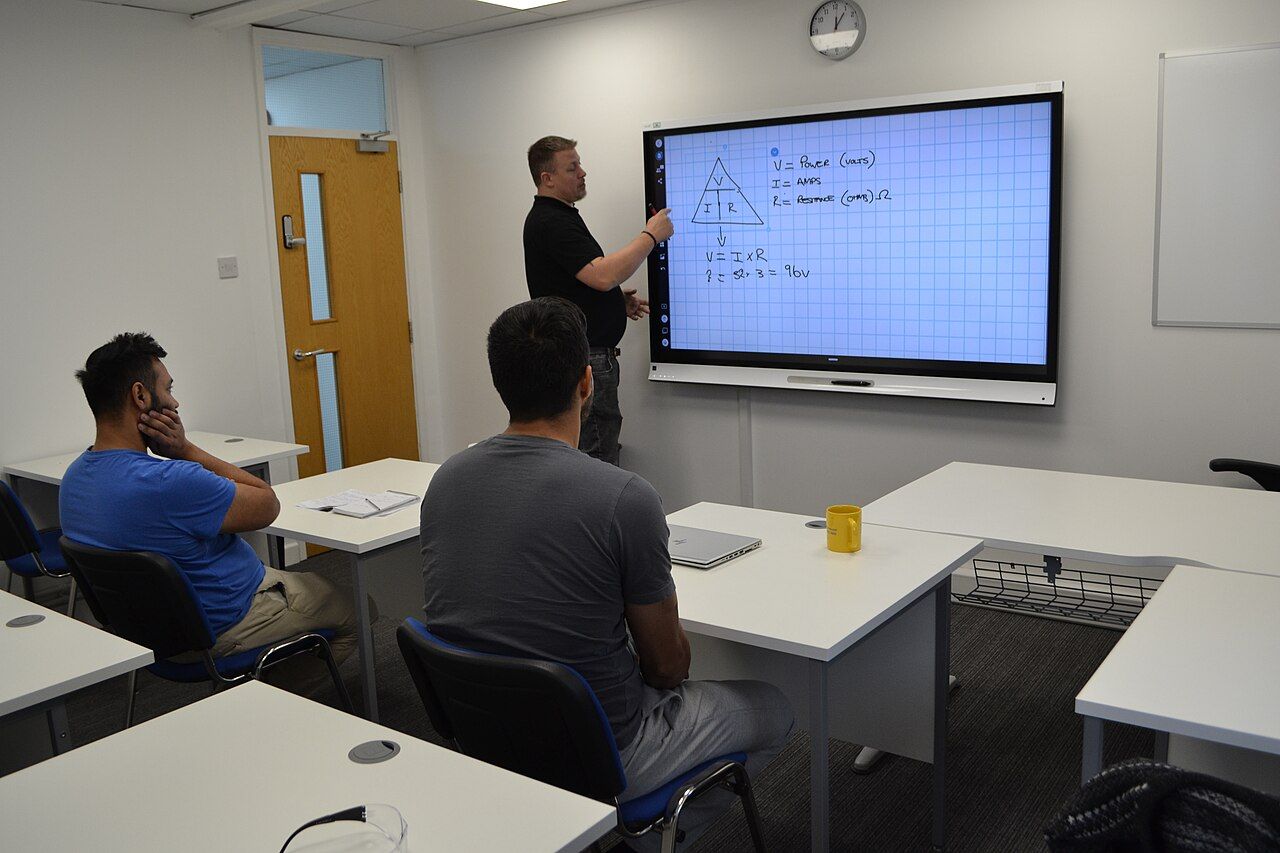 Tutor answering a question during an adult-learning classroom session
